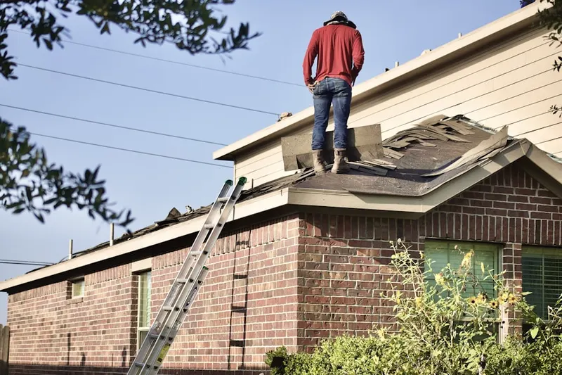 Professional roofer working on a residential roof in Sun City Festival
